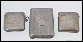 Two early 20th century silver hallmarked vesta's along with a white metal cheroot holder. 88.