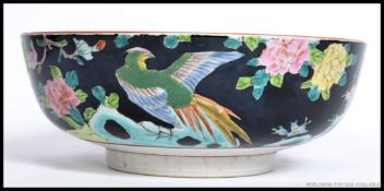 A Chinese famille rose fruit bowl with black ground having floral sprays,