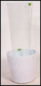 A large floor standing glass vase  / planter by Ikea together with a ceramic planter.