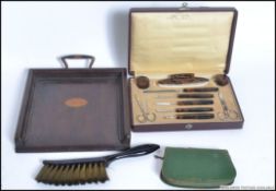 A boxed tortoiseshell manicure set and a puch manicure set with a crumb tray and brush