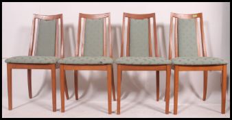 A set of 4 1970's retro teak wood dining chairs.