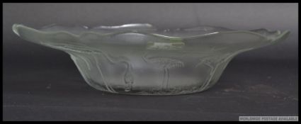 A large 20th century pressed glass dish in the style of Lalique,
