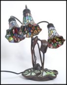 A 20th century Tiffany style lamp having decorative base with stained glass half moon shade.