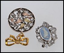 A silver, bronze and copper fern leaf brooch,