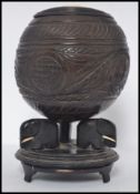 An Asian carved coconut - tribal art centrepiece with bone inlaid lozenge,