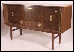 A retro  1960's melamine faux wood sideboard raised on tapered legs with inset bank of drawers and
