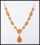 A 20th century silver and amber pendant necklace chain together with a matching bracelet