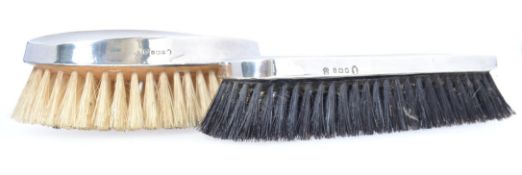 Two vintage hallmarked silver topped clothes brushes.