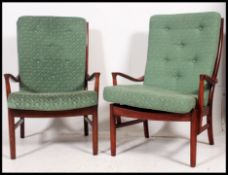A pair of Parker Knoll retro teak wood armchairs.