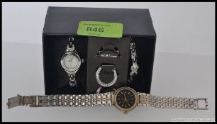 A boxed Ingersol ladies watch with inter changeable facia and straps along with another ladies