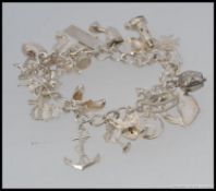 A good silver charm bracelet with multiple charms etc  ( see illustrations )