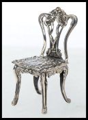 A well detailed 925 white metal / silver miniature Chippendale style chair. 11.