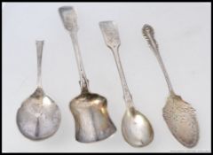 A collection of four silver hallmarked spoons - A shovel shaped caddy Exeter 1851 - makers mark J.