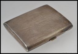 A silver hallmarked cigarette case having plain rectangular cartouche with hallmarks for Samuel M