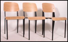 A set of 3 contemporary Industrial style wooden chairs with black legs and ply wood panel seats and