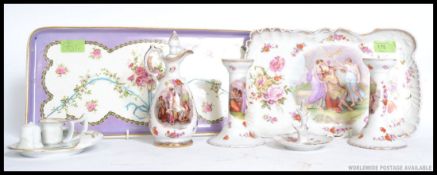 An early 20th century porcelain dressing table set with tray, bottle, candlesticks and stand.