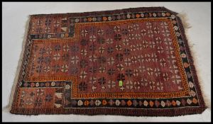 An early 20th century handwoven prayer rug.