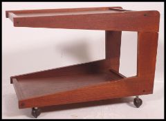 A retro 1960's unusual style low angular tea trolley magazine table with castors to base