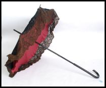 A Victorian ebonised ladies silkwork parasol / umbrella, with shaped handle and original lacework.