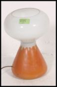 A 1960's glass two tone retro mushroom lamp in orange and white in the manner of John Ditchfield.