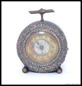 A silver faced ( dated 1907 ) mounted circular strut bedside timepiece,