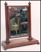A large Victorian mahogany swivel dressing mirror on carved scroll supports H86cm W71cm together