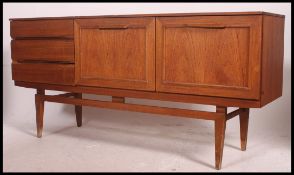 A 1970's retro teak wood Danish influence sideboard comprising a series of drawers and cupboards.