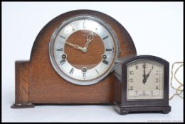 A mid century Smiths oak cased mantle clock along with a smaller Smiths Bakelite electric clock.