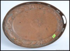 An Arts and Crafts Newlyn Style fret pierced oval galleried copper tray,