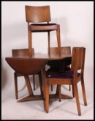 An art Deco Oak drop leaf dinning table along with four matching dining chairs,