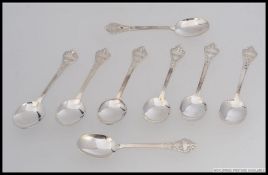 A set of 8 silver hallmarked spoons having chased scrolled bowls and handles.