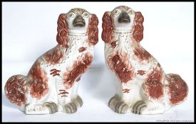 A pair of large 19th / 20th  century Staffordshire pottery fireside dogs,
