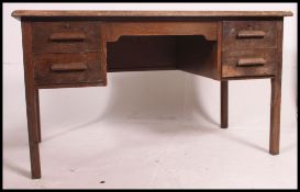 A 1930's to mid century oak twin pedestal air ministry style desk having a twin bank of drawers