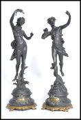 A pair of Spelter figures raised on socle bases after Ferrand of a  young girl with a mandolin with