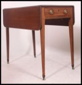 A Georgian mahogany Pembroke table. Raised on squared tapering legs with single end frieze drawers.
