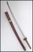 A 20th century replica Japanese Samurai sword, having a faux shagreen grip above the tsuba,