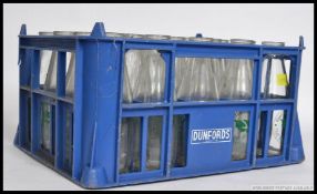 A vintage Dairy Industrial advertising milk bottle crate complete with bottles having notation.