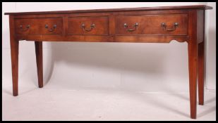 A fabulous 20th century French cherry wood sideboard dresser raised on squared legs with a series