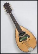 An early 20th century eight string cased Neapolitan bowl-back mandolin,