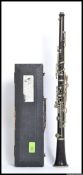 An early 20th century clarinet complete in the original tapering leather covered case with handle