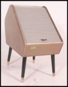 An unusual vintage retro mid century rolladex style tambour storage cabinet raised on ebonised