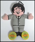 A vintage Paul McCartney Beatles fabric doll along with a pair of Sgt Peppers Lonely Hearts Club