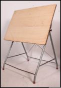 A mid century Industrial architects table having wooden angular work top.