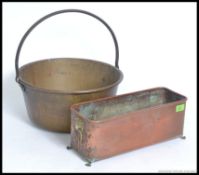 A 19th century copper and brass planter with lion head masks. Together with a large brass jam pan.