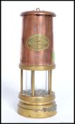 A Ferndale Colliery brass and copper miners lamp. Glass intact with notation lozenge to centre.
