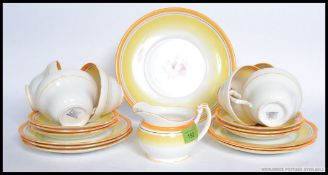 A vintage Foley china part tea service, each decorated with yellow lines and florals.