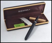 A vintage Schaeffer fountain pen with yellow metal cap complete in presentation case