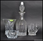 A collection of cut glass / crystal items to include a heavy decanter, vase, vessel and dish.