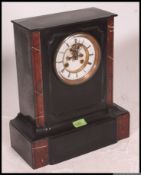 A Victorian black slate and rouge marble mantle clock of architectural form,