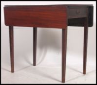 A 19th century mahogany Pembroke table being raised on tapered legs with a single drawer to one end
